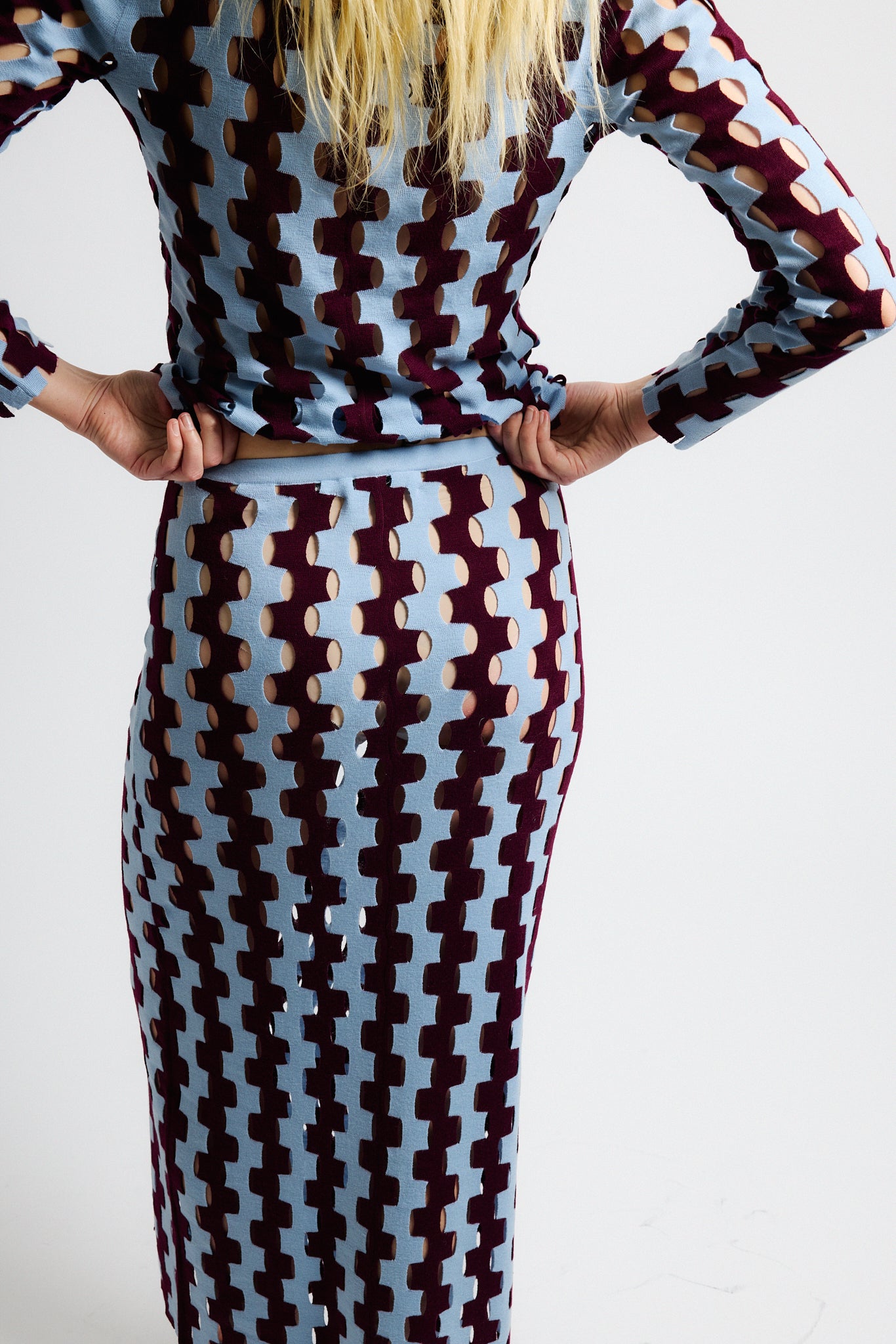 Link to "Marshall" skirt. Image is of a female model wearing burgundy and baby blue zig-zag striped long sleeve scoop-neck shirt and long skirt. 