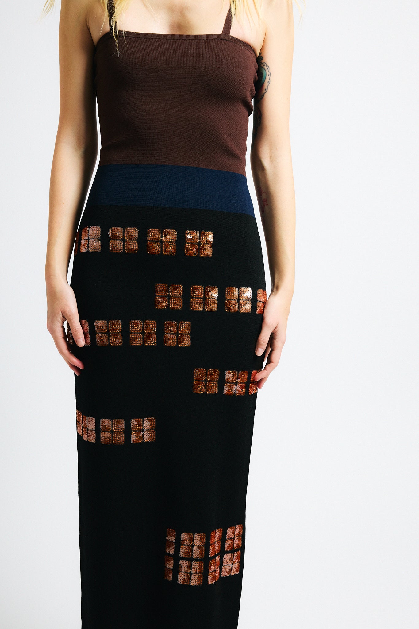 Link to "Antonia" dress. Image is of a female model wearing strapless brown/black sequin dress. 