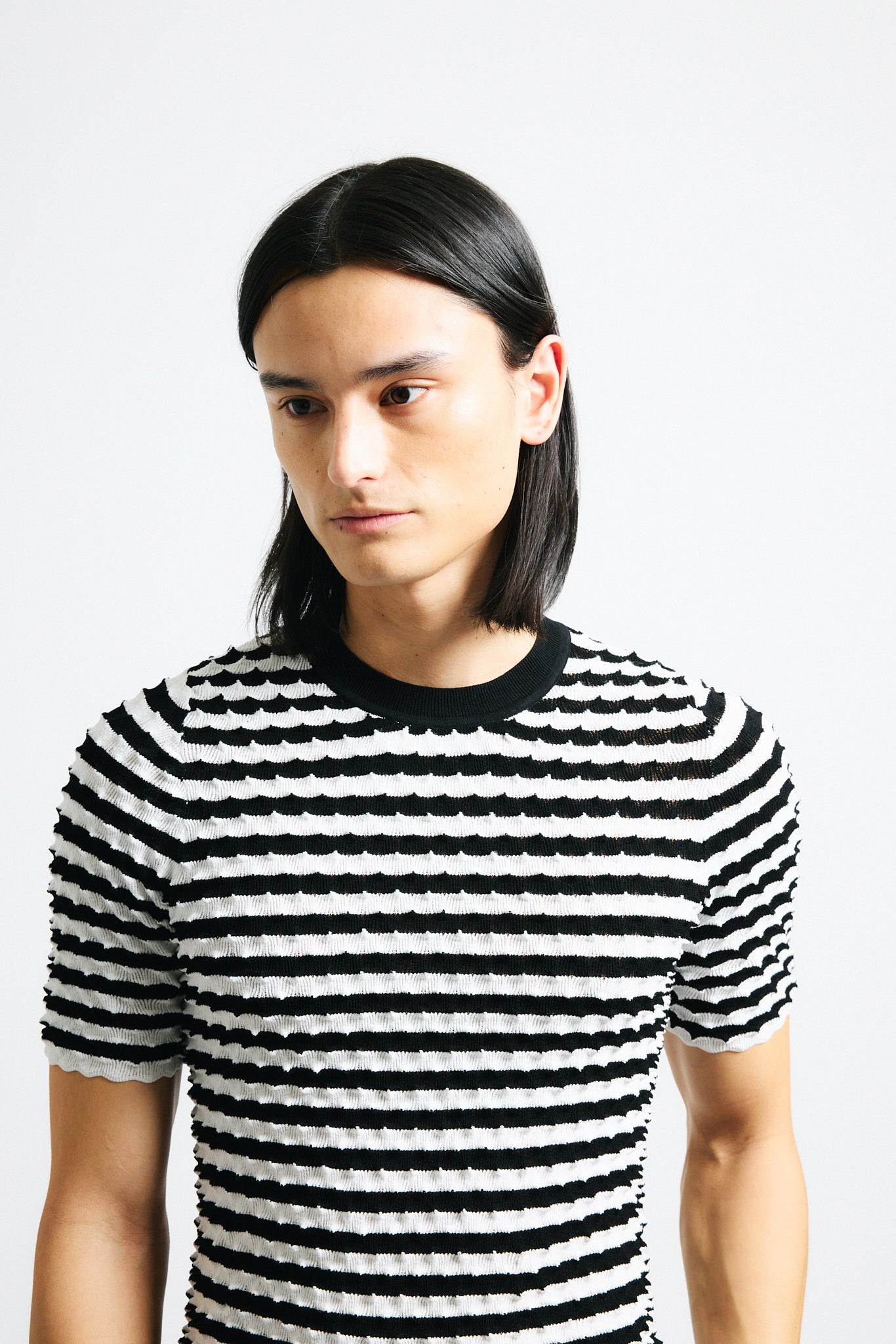 Link to "Elodie" shirt Image is of a male model wearing black and white horizontal stripe knit crewneck shirt.