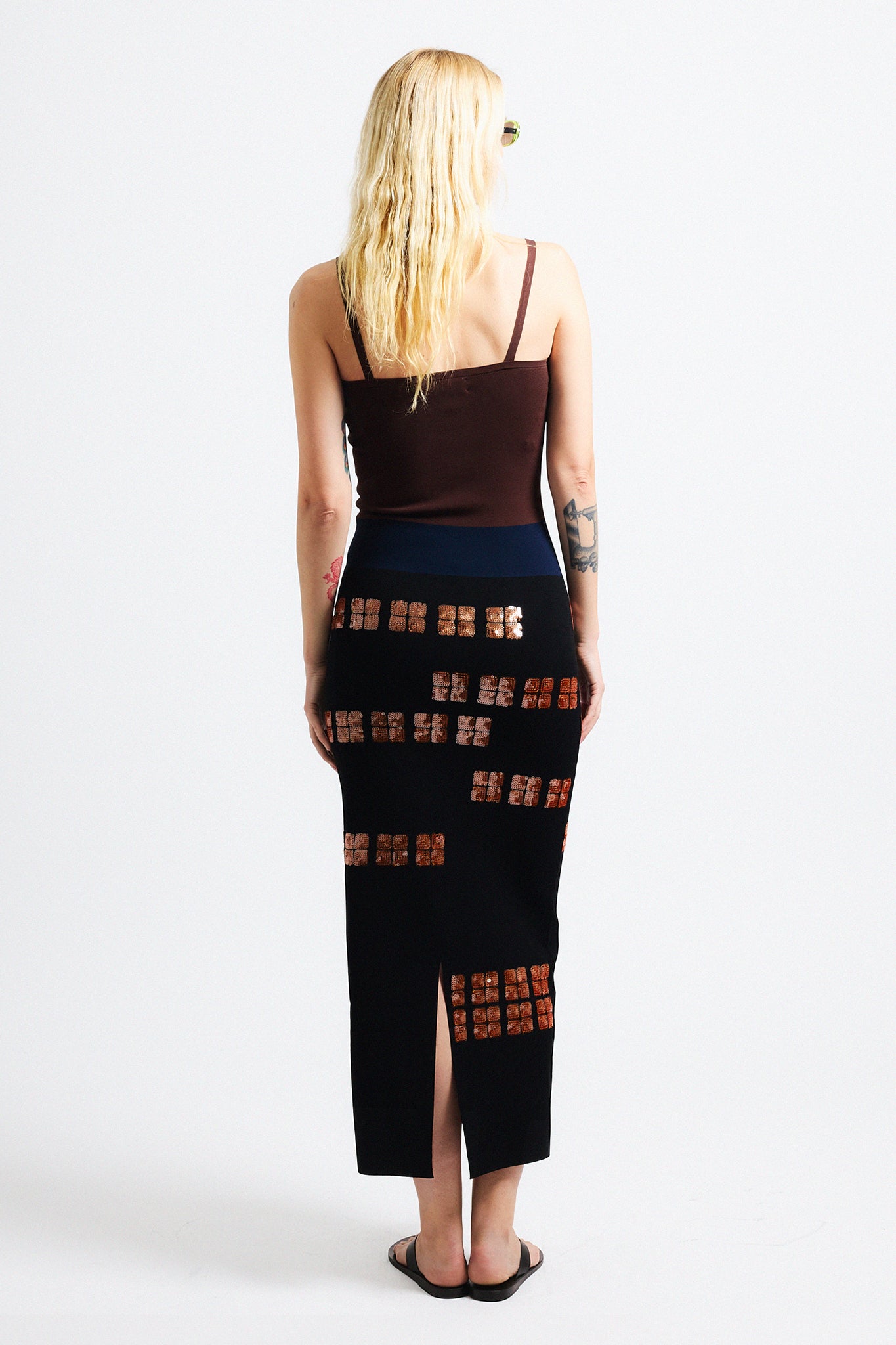 Link to "Antonia" dress. Image is of a female model wearing strapless brown/black sequin dress. 